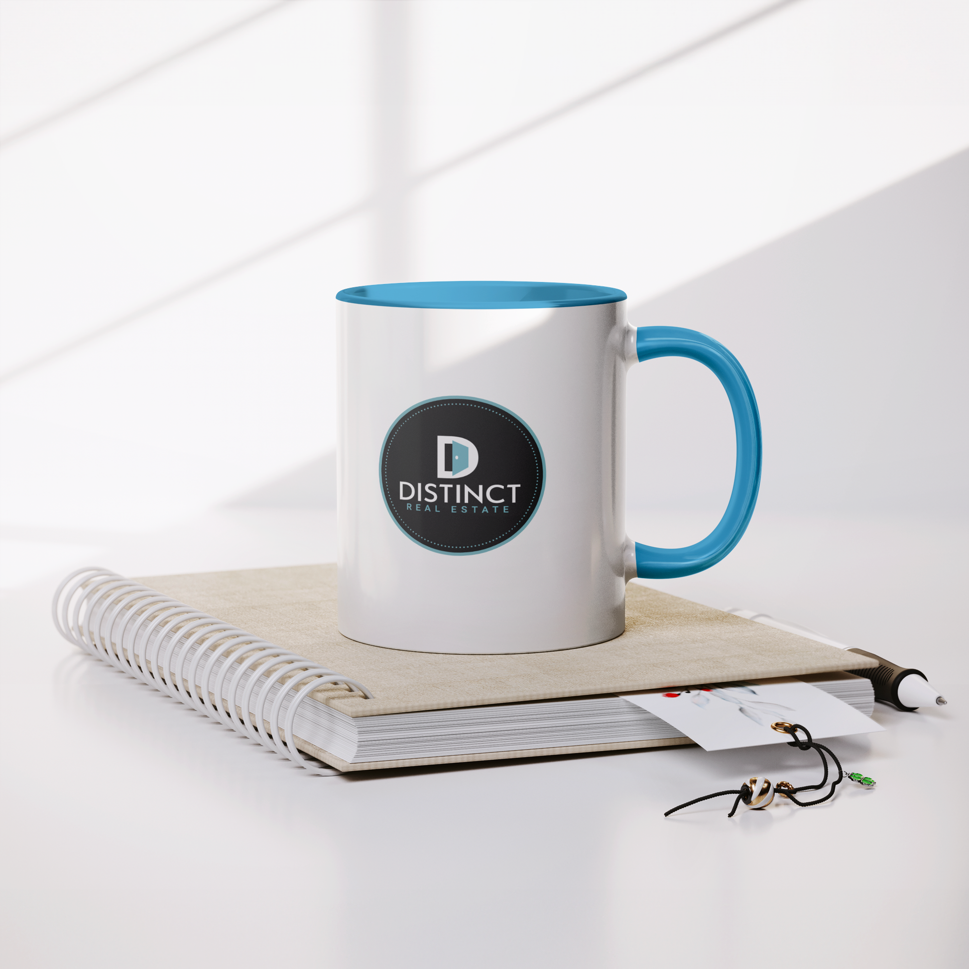 Blue_Accent_White_Mug_with_Circle_logo_Lifestyle_Notebook_Mockup.png