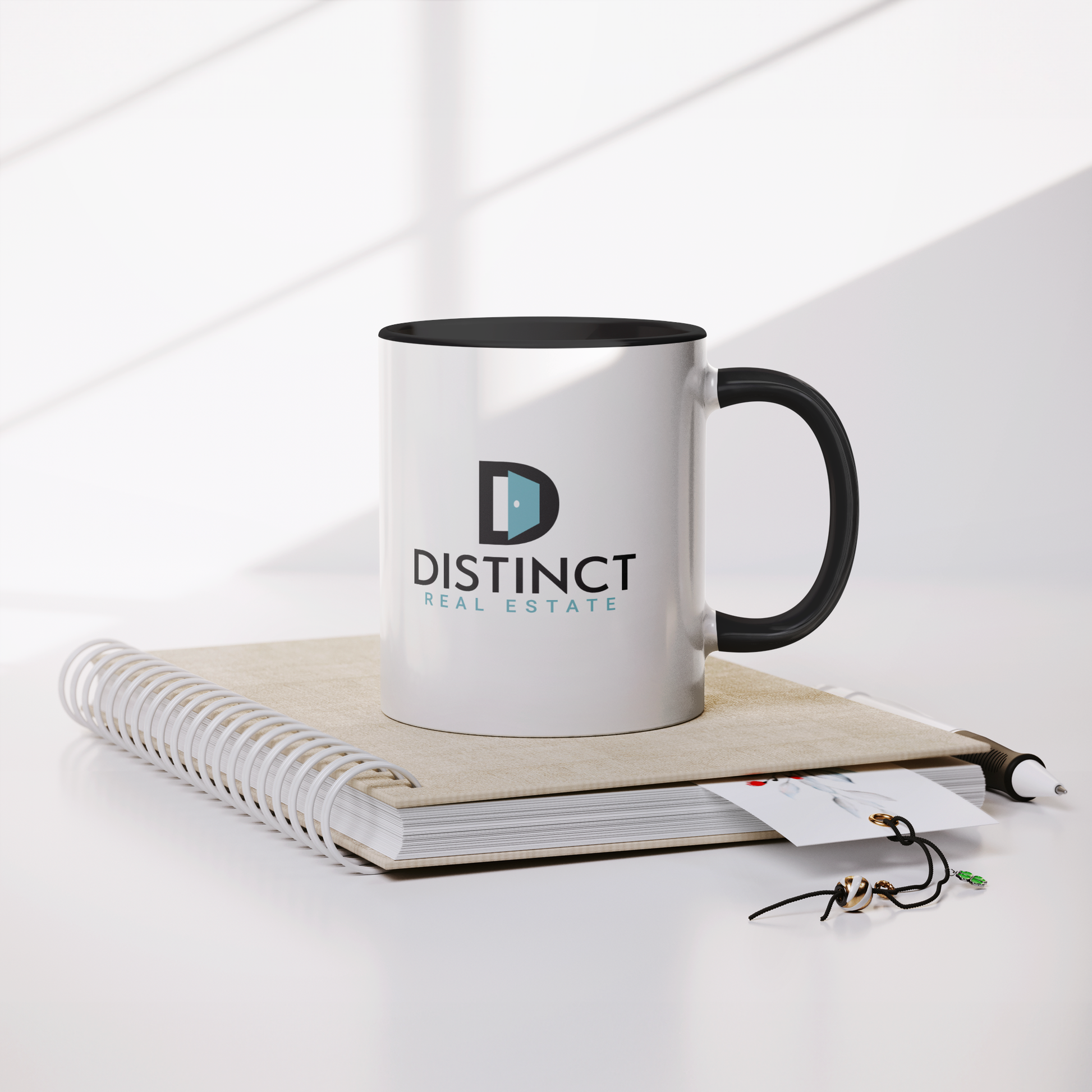 Blue_Accent_White_Mug_with_logo_Mug_Lifestyle_Notebook_Mockup.png