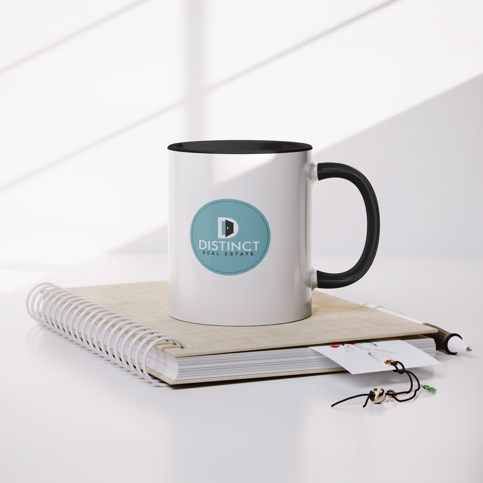 Distinct_Black_Accent_White_Mug_with_Cir_Mug_Lifestyle_Notebook_Mockup.png