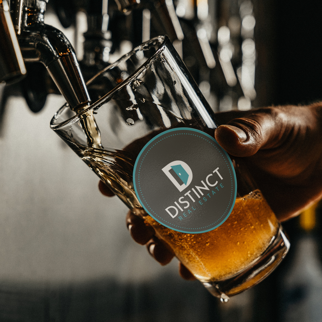 Distinct_Real_Estate_-_16oz_pint_glass_Pint_Glass_Dark_Lifestyle_Mockup.png