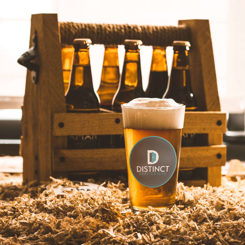 Distinct_Real_Estate_-_16oz_pint_glass_Pint_Glass_Light_Lifestyle_Mockup.png